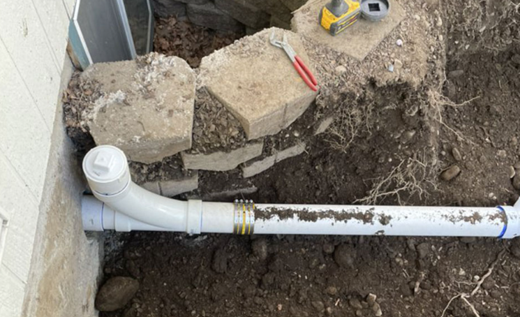 An open sewer inspection chamber in a garden
